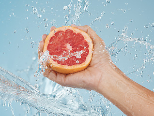 Image showing Grapefruit, fruit and water for health of body and skin with natural diet to lose weight or skincare with dermatology food. Hand holding vitamin c snack for a healthy lifestyle or female orgasm