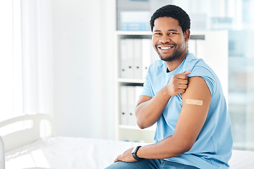 Image showing Black man, band aid and covid vaccine success in hospital in global virus safety, security or life insurance wellness. Portrait, happy smile and covid 19 injection patient with healthcare arm plaster