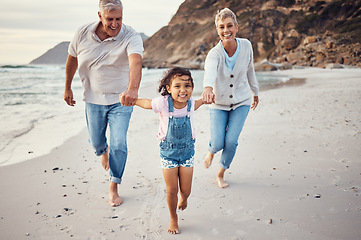 Image showing Beach, running and child holding hands with grandparents for a lovely bonding experience on holiday vacation. Happy, grandmother and old man having fun enjoying an exercise with a kid as a family