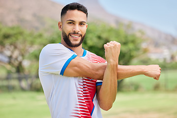 Image showing Fitness, portrait and soccer player stretching in training, workout and warm up exercise on a soccer field. Smile, healthy and happy sports man ready to start playing a football match or game in Peru