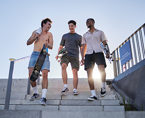 Image showing friends, walking with skateboard together in city outdoors for fun, laugh and conversation support. Diversity, young gen z men talking and sport fitness lifestyle or urban trendy street fashion