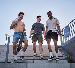 Image showing Friends, city and walking with skateboard on steps, street or outdoors. Sports, skateboarding and group of skaters together after skating practice, fitness training or exercise workout in town.