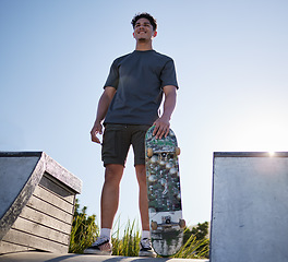 Image showing Skateboard, sports and man on ramp at community skate park for freedom, exercise and fitness with smile and thinking about goal, motivation and dream. Happy skater male outdoor for fun and adventure