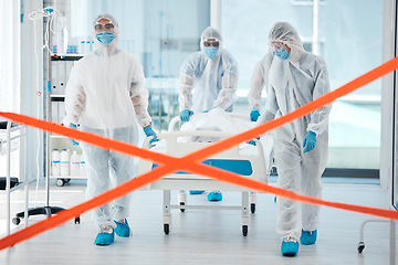 Image showing Covid quarantine, medical team and patient in bed, moving to isolation or test area with warning tape in hospital. PPE suits, safety and healthcare, group of doctors or nurses move body on stretcher.