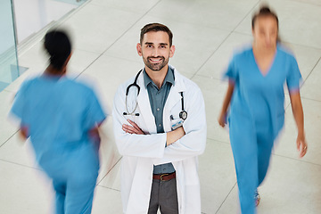 Image showing Leadership, wellness or happy doctor in hospital with smile for motivation, insurance or healthcare with blurred busy background. Medicine, smile or nurse for health, medical help or vision in clinic