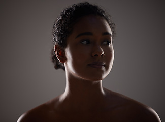 Image showing Beauty, skincare and face with a model woman in a dark studio on a gray background for health or wellness. Cosmetics, natural and skin with an attractive young woman posing to promote antiaging care