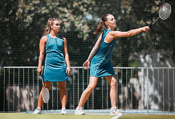Image showing Badminton, sports and women with a serve on an outdoor court busy with fitness and exercise. People training, cardio and athlete workout of sport student teamwork and collaboration together