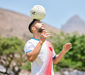 Image showing Sports, soccer and man soccer player training, balance and ball, head and soccer field, practice and cardio. Football, football player and trick during fitness, workout and exercise by mexican player