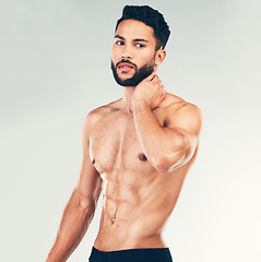 Image showing Bodybuilder, strong and topless man showing his abs and fit body on a stufio background. Fitness, shirtless handsome young man and posing for strength, muscle and bodybuilding or weightlifting