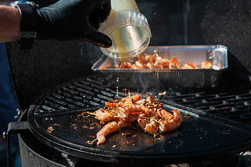 Image showing A professional cook prepares shrimps