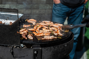 Image showing A professional cook prepares shrimps