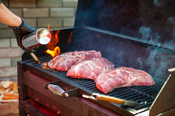 Image showing Pork meat steaks on the grill