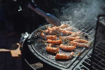 Image showing A professional cook prepares shrimps