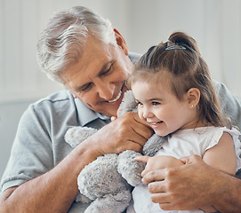 Image showing Grandfather play with grandchild girl in living room, lounge and family home with teddy bear toys, fun and happiness in Australia. Happy senior grandparent man relax with young kids together in house