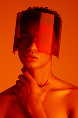 Image showing Orange, futuristic and man with a neon visor for cyberpunk, creative style and art against a studio background. Digital, fashion and face portrait of a model with a designer product for future