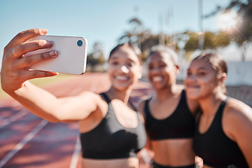 Image showing Sports, women and selfie with runner group at a running track for fitness, training and workout outdoors. Friends, phone and girl athlete team bond, smile and take picture at a stadium for exercise