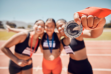 Image showing Medal, winner team and athlete women, competition and success at sports stadium, arena and running track for race, olympics and world championship games. Excited runner group in pride for achievement