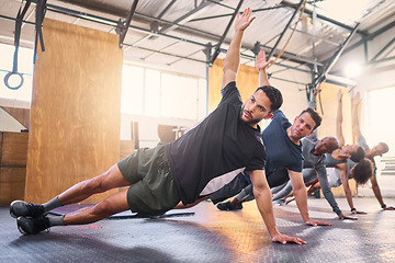 Image showing Strong man, personal trainer and group training with side plank exercise, workout and fitness in gym club. Bodybuilder coach teaching sports class, bodyweight wellness challenge and strong people