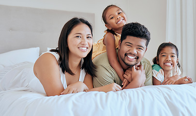 Image showing Happy, asian and family bedroom portrait together with smile, children and care in loving home. Happiness, relax and mother with father on bed for rest, bonding and leisure with young children.
