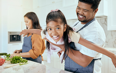 Image showing Mother, father and child play while cooking in the kitchen bonding, laughing and having fun happy family home, Smile, mama and dad enjoy playing with girl or kid in a healthy dinner meal preparation