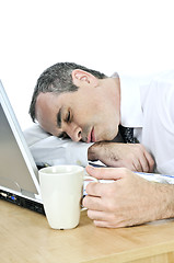 Image showing Businessman asleep at his desk on white background