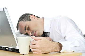 Image showing Businessman asleep at his desk on white background