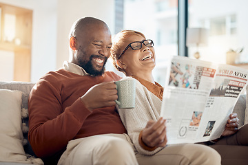 Image showing Happy, smile and couple reading a newspaper while relaxing on a sofa in the living room of their home. Happiness, love and mature interracial people laughing, resting and bonding together at a house.