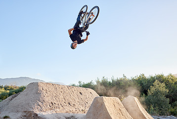 Image showing Bike, nature and outdoor sports while biking doing dangerous jump in air for fitness, exercise and training with athlete energy. Man cycling with bicycle at park for mountain bike freedom adventure