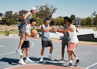 Image showing Basketball player, fist bump and friends celebration for training goal, game achievement or teamwork success at outdoor court in urban city park. Group of people or men celebrate on basketball court