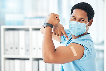 Image showing Man, covid face mask or muscle flex in hospital, clinic or pharmacy with vaccine plaster, bacteria medicine or healthcare trust. Portrait, black person or pointing at covid 19 band aid in compliance