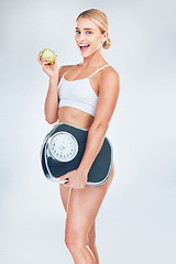 Image showing Apple, fitness and woman with a scale for fat loss with a healthy diet after a workout, exercise and training. Weightloss, portrait and happy girl with a weight scale eating fruit for nutrition