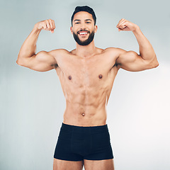 Image showing Fitness, biceps and man flexing arms on studio background with muscle growth and development in training exercise. Workout, gym and happy healthy bodybuilder from Mexico, muscles, health and wellness