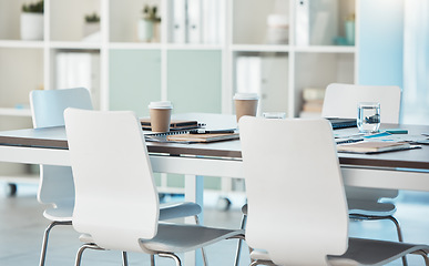 Image showing Interior, meeting and empty office for a presentation with a table, chairs and paperwork for a corporate audience. Startup, conference room and boardroom space or a business meeting room building