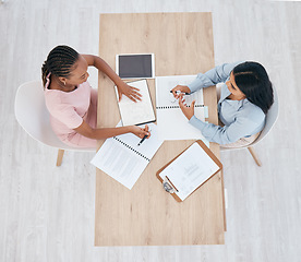 Image showing Collaboration, team and women working on data, seo and analytics from above. Teamwork, data and paperwork or documents for digital marketing campaign. Organized, planning and businesswomen brainstorm