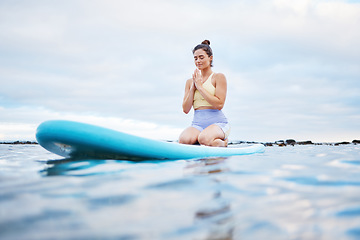 Image showing Yoga meditation, ocean and surfer woman meditating for health wellness, peace or freedom on sea water. Surfboard pilates, prayer and zen girl meditate for beach fitness, aura or chakra energy healing