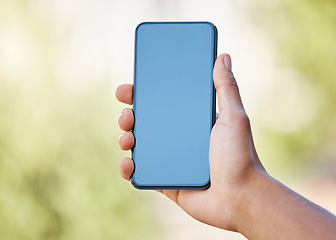 Image showing Smartphone, screen mock up and hand in nature for mobile app, social media or website advertising, marketing or product placement. Holding phone for internet travel mock up, 5g network or ux design