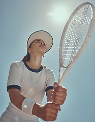 Image showing Professional tennis player, fitness and woman athlete playing sports, match and games with tennis racket on blue sky lens flare. Below of tennis girl with focus mindset in training to win competition