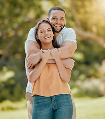 Image showing Young couple hugging in park, garden and nature for love, care and romantic date together outdoors in Colombia. Portrait of smile, laughing and relax couple in happy marriage and joyful relationship