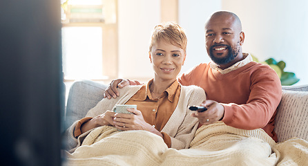 Image showing Mature couple, bonding or watching tv on sofa in house or home living room on streaming channel or multimedia subscription. Happy smile, black woman and man with television movie show or relax coffee