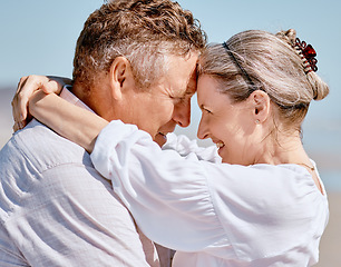 Image showing Love, romance and beach with a senior couple hugging outdoor in nature while enjoying a retirement vacation. Travel, summer and together with a mature man and woman pensioner bonding on the coast