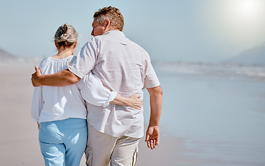 Image showing Love, senior couple and beach for walking, vacation and happy being loving together, travel or hug. Romance, mature man and elderly woman embrace on tropical island, relax or seaside sand for holiday