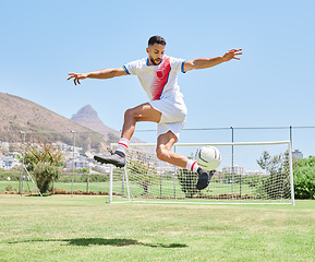 Image showing Soccer player field, man soccer ball trick and control outdoor on grass for sports, fitness and health. Jump football skill, young sport athlete and kick freestyle on pitch for wellness in Cape Town