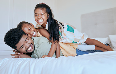 Image showing Happy family, dad and girl kids on bed in home with smile, portrait father and children play together in Asia. Love, fun and family time for dad and daughters in bedroom in family home in Indonesia