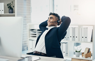 Image showing Computer, call center and stretching businessman in relief, success or done crm sales deal, telemarketing goals or crm target. Happy smile, relax and customer support worker hands behind head on tech