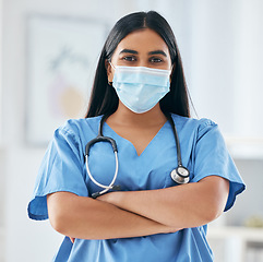 Image showing Nurse, doctor and covid face mask in hospital with motivation, confidence and arms crossed. Health expert or medical worker with support in the covid 19 pandemic, healthcare and safety from virus