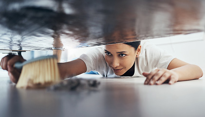 Image showing Woman, hand broom or sweeping dust in house, home or hotel bedroom in housekeeping cleaning, cleaner service or hygiene maintenance. Brush, dirty or messy floor spring cleaning under hospitality sofa