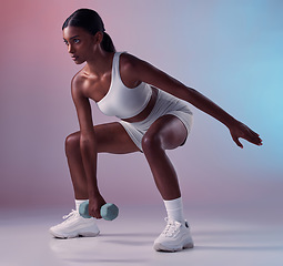 Image showing Fitness, dumbbell and girl in studio training, exercise and workout for strong powerful arms and muscles. Wellness, healthy and young Indian woman lifting dumbbells exercising full body with energy