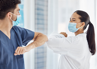 Image showing Doctors, elbow greeting and covid safety in social distancing, compliance or regulations at the hospital. Medical professionals greet with arms for health and safety during pandemic at the workplace