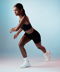 Image showing Fitness, body and workout woman in a studio mock up for fashion advertising or marketing. Young Indian girl sports runner with health training, wellness and exercise lifestyle on gradient blue mockup