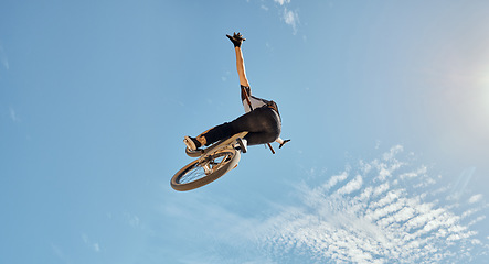 Image showing Bicycle stunt, man cycling in air jump on blue sky mock up for sports action performance, fitness training or outdoor bike performance. Professional sports person with bmx bicycle adventure mockup